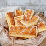 Goldbraune Vanillepuddingstangen mit Zuckerguss in einem Brotkorb