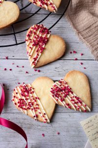 Herzkekse aus Mürbeteig und mit Schokoladen-Himbeeren-Topping
