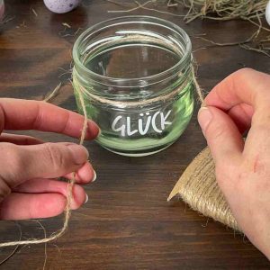 Juteband wird um das Glücksglas gewickelt