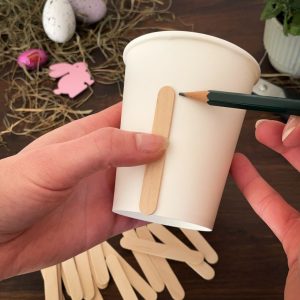 Holzstäbchen-Markierung wird an dem Pappbecher eingezeichnet