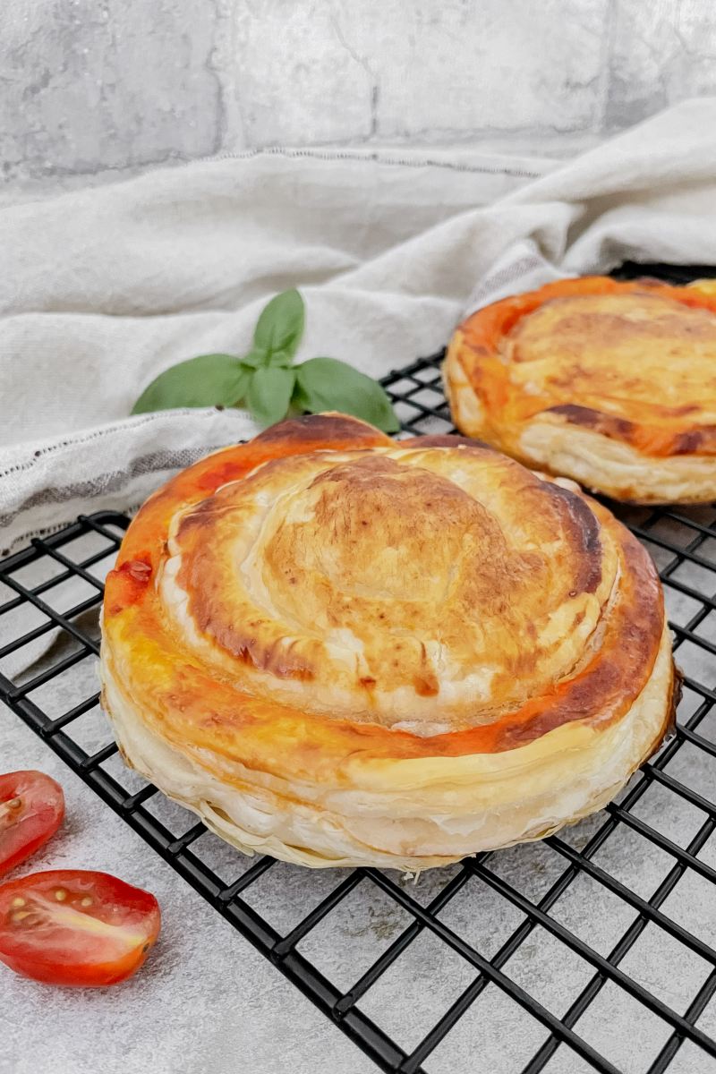 Zwei fertig gebackene Rustico Leccese auf einem Abkühlgitter